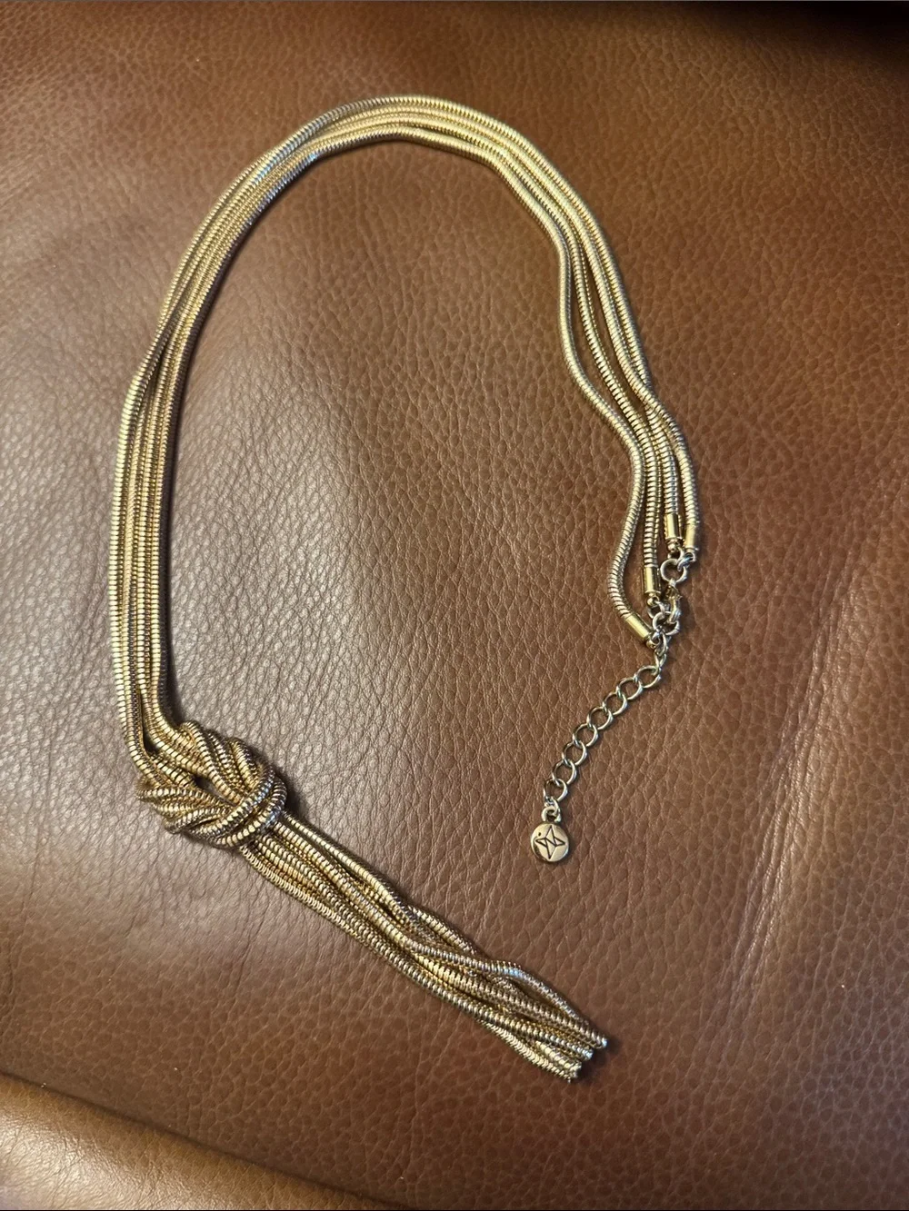 Multi-strand gold tone snake chain knotted tassel necklace